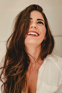 A woman with glowing skin smiling